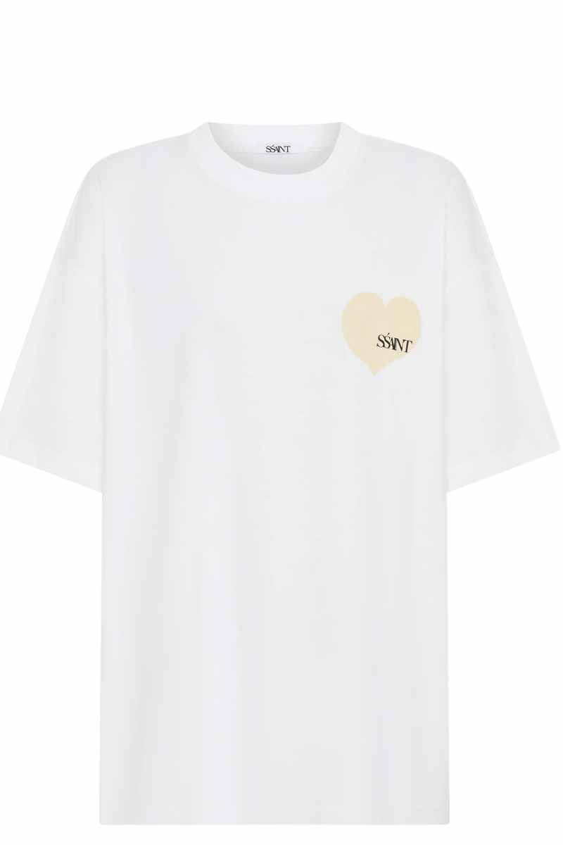 SSAINT white oversized T shirt with cream small heart in left hand corner with black ssaint writing in it front view 